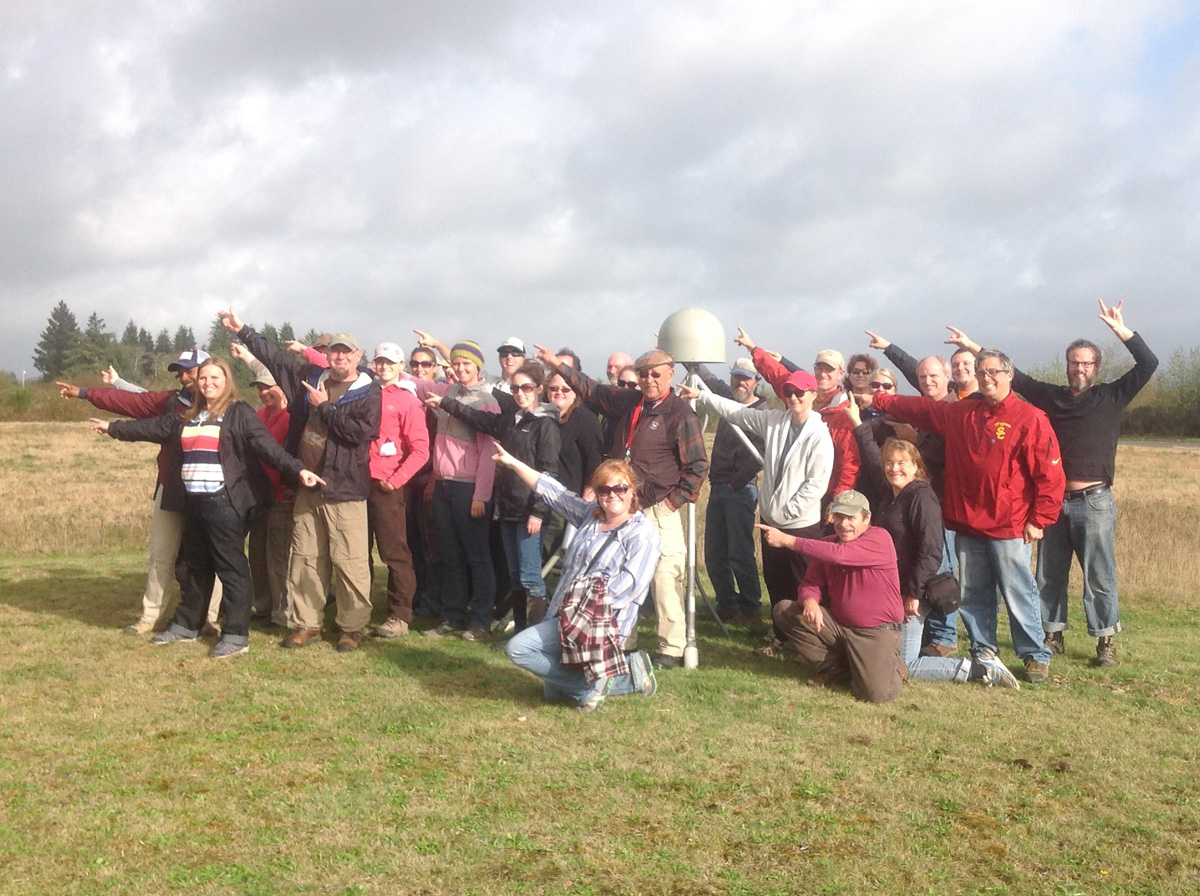 CEETEP participants from October 2014 workshop at GPS station P401 (Quillayute Airport near Forks, Washington) showing the direction of plate motion relative to stable North American (northeast)