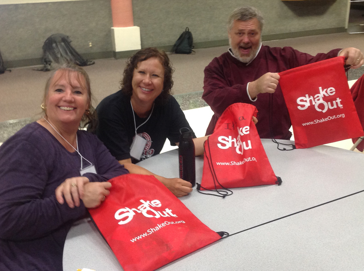 Participants at Aberdeen 2014 workshop show off their ShakeOut bags which they will use with learners.